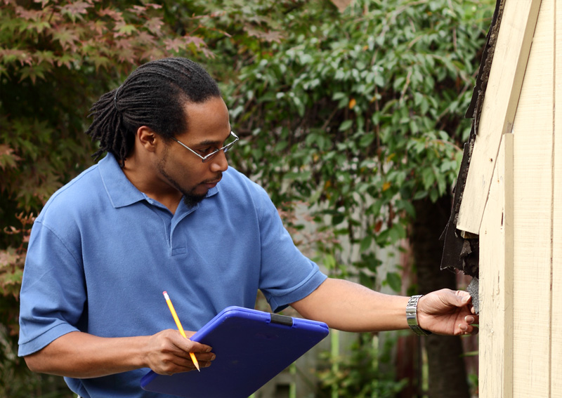 Insurance Agent Inspects Home